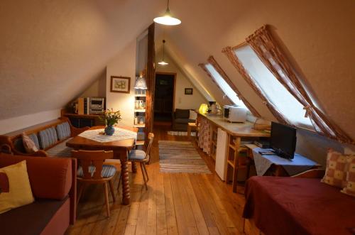 a living room with skylights and a kitchen with a table at Altes Gehöft am Lormanberg in Kirchberg an der Raab