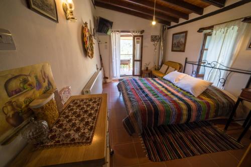 a bedroom with a bed and a table in a room at Hatzikyprianou Museum Studio in Lazania