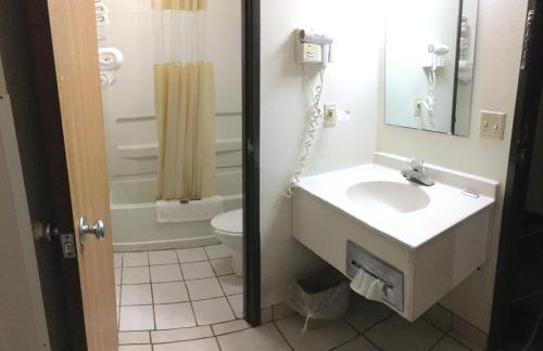 a bathroom with a sink and a toilet at Anderson Chesterfield Travel Inn in Daleville