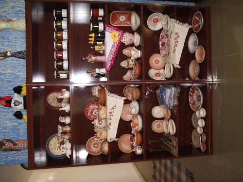 a shelf with many different types of items on it at Pousada Canto da Maritaca in Resende Costa