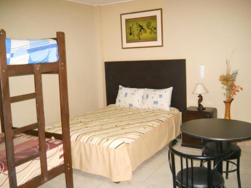 a bedroom with a bunk bed and a table at Septima Maravilla in Lima