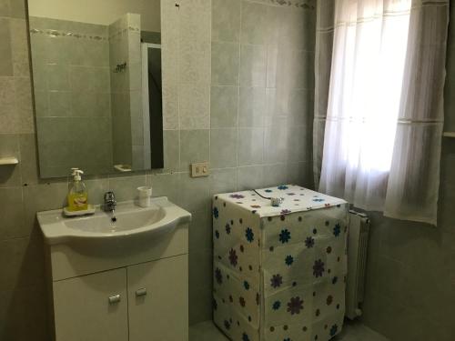 a small bathroom with a sink and a mirror at Azienda Multifunzionale S'Ozastro in Santa Marinella