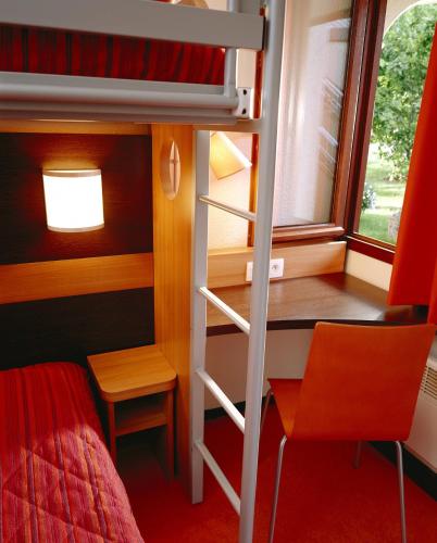 a bedroom with a bunk bed and a desk and a bed at Premiere Classe Lille Ouest - Lomme in Lomme