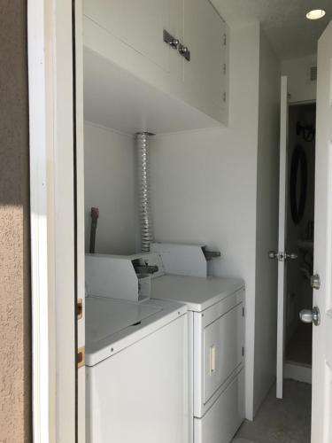 a kitchen with white cabinets and a sink at Pyramid Resort Motel in Wildwood Crest