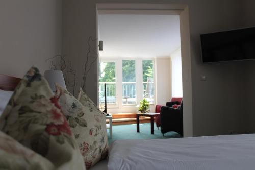 a hotel room with a bed and a window at Hotel Villa Passion in Malchow