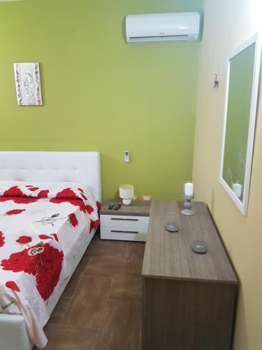 a bedroom with a bed and a desk in it at Appartamento Marinella in Pizzo