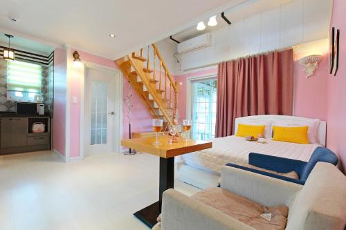 a bedroom with a bed and a table and chairs at Yejeon Pension in Gyeongju