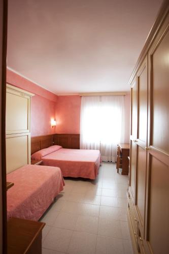 a hotel room with two beds and a window at Hotel Sporting in Roccaraso