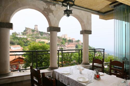 a restaurant with a table with a view of a mountain at Hotel PANORAMA Kruje view on the castle and the old town in Krujë