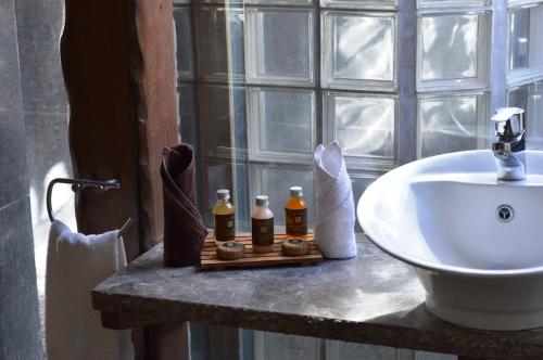 a bathroom with a sink and a counter with a white sink at Aitutaki Escape in Arutanga