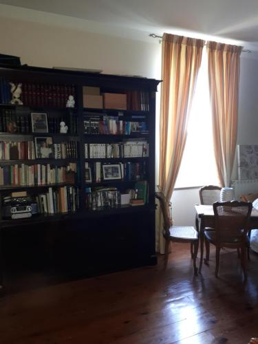 a living room with a book shelf filled with books at Villa SAINT-PRIVAT in Pouzilhac