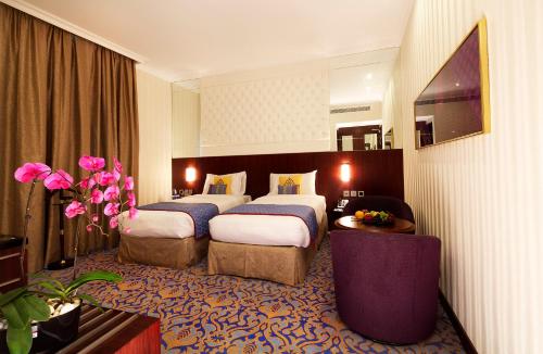מיטה או מיטות בחדר ב-Raviz Center Point Hotel