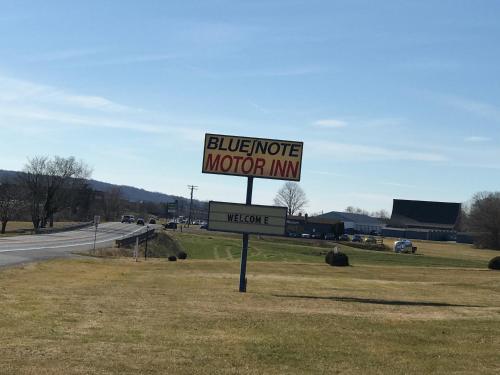 a sign for a motel on the side of a road at Blue Note Motor Inn in Marietta