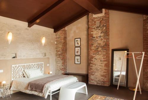 ドリアーニにあるCasamerla Doglianiのレンガの壁、ベッド付きのベッドルーム1室