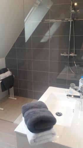 a bathroom with a sink with towels on it at Les Chambres Chez Christine in Ottrott