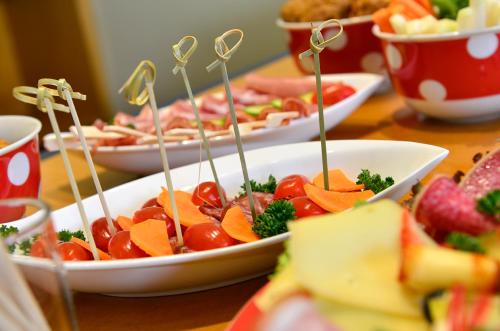 a table topped with plates of food on sticks at ACHAT Hotel Suhl in Suhl