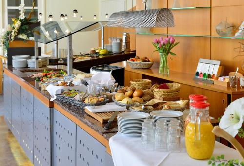a buffet line in a restaurant with food at ACHAT Hotel Suhl in Suhl