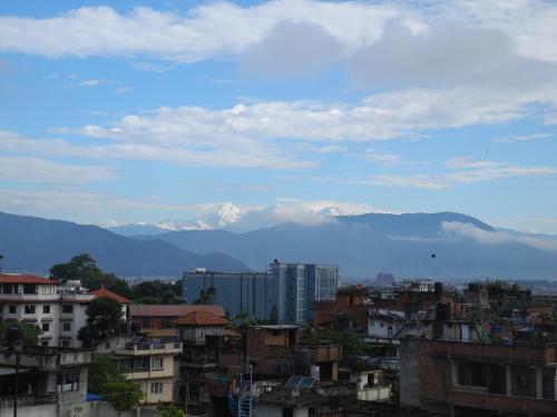a view of a city with mountains in the background at Tajaa Pha The Heritage Home in Pātan