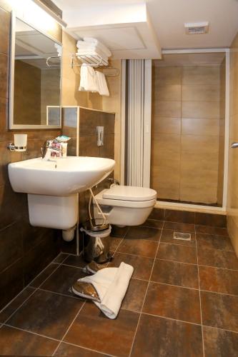a bathroom with a sink and a toilet at City Tower Hotel in Aqaba