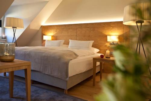 a bedroom with a bed with two tables and two lamps at Gasthof Zufriedenheit in Naumburg