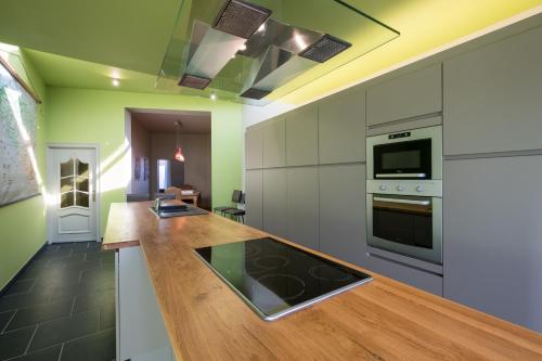 a kitchen with a wooden counter top in a room at Sekowa-lodge in Geraardsbergen