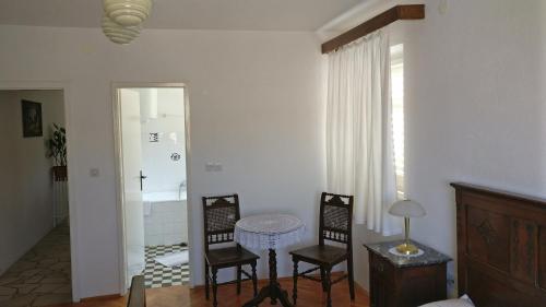 a room with two chairs and a table and a window at Guesthouse Lidija in Sutivan