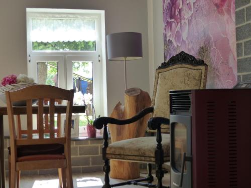 a living room with a chair and a piano at Ferienhaus Arendsee in Arendsee
