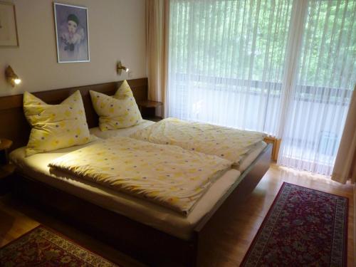 a bed in a bedroom with a large window at Apartment Anna in Bad Gastein