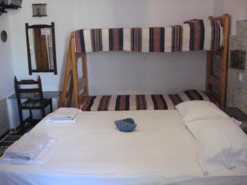 a bed in a room with a bunk bed at Pension Irini-Vicky in Ios Chora