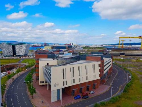 a building with a clock on it in a city at CK Serviced Apartments Belfast in Belfast