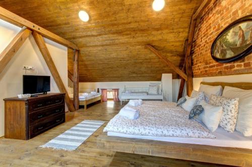 a bedroom with a large bed in a attic at Slezský Grunt in Háj ve Slezsku