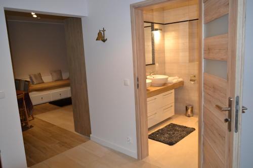 a bathroom with a sink and a toilet in a room at Apartamenty Willa Nawigator in Gdynia