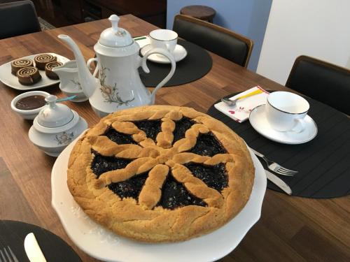 a pie sitting on a plate on a table at B&B Vista su Roma in Marco Simone