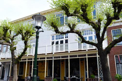 a street light in front of a building with trees at 2L Hof van Holland apartments in Noordwijk