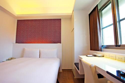 Postel nebo postele na pokoji v ubytování Taitung Yes Hotel