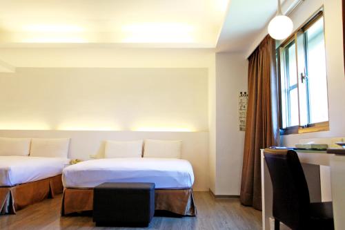 Postel nebo postele na pokoji v ubytování Taitung Yes Hotel