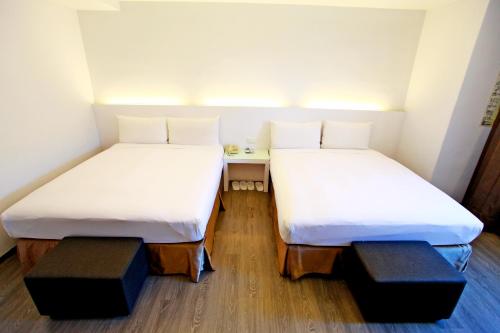 Postel nebo postele na pokoji v ubytování Taitung Yes Hotel