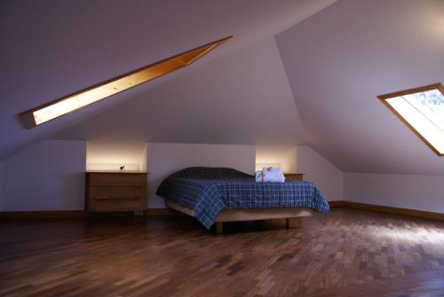 a bedroom with a bed in a attic at Loft Paços da Vila in Ribeira Brava