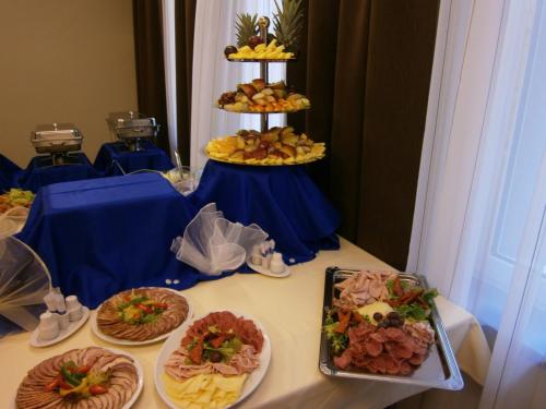 a table with several plates of food on it at Hotel 99 in Chomutov