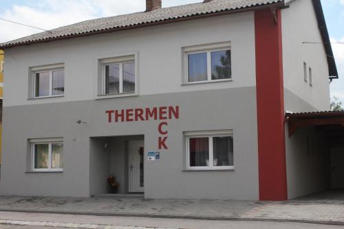 a white building with a red sign on it at Appartementhaus Thermeneck in Laa an der Thaya