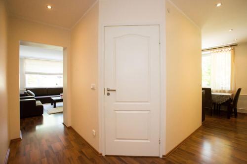 a white door in a room with a living room at Katariina Apartment in Võru