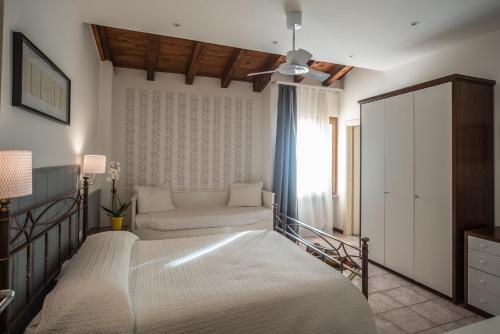 a bedroom with a bed and a couch and a window at La Sosta Hotel in Vestone