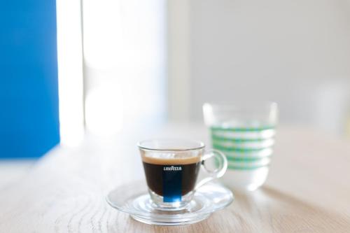 a cup of coffee on a plate on a table at Anemomilos in Oia