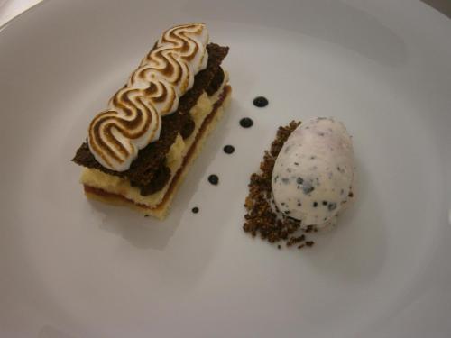 a white plate with a piece of cake and a dessert at Hotel 99 in Chomutov