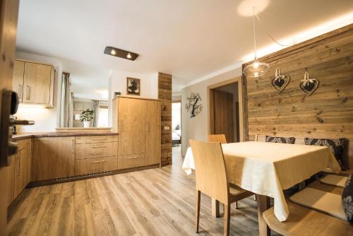 a kitchen and dining room with a table and chairs at Apartment Sella in Siusi