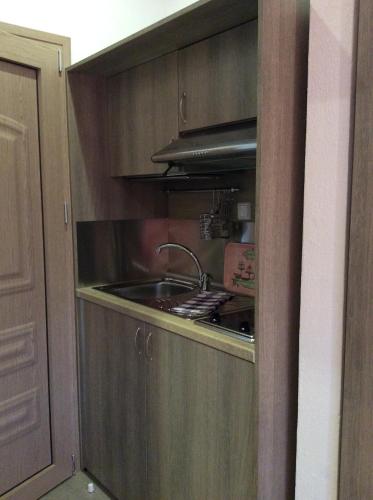 a kitchen with a sink and a stove at Studios Nopi-Zoi in Skiathos Town