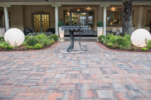a stone patio with a table in front of a building at La Sosta Hotel in Vestone