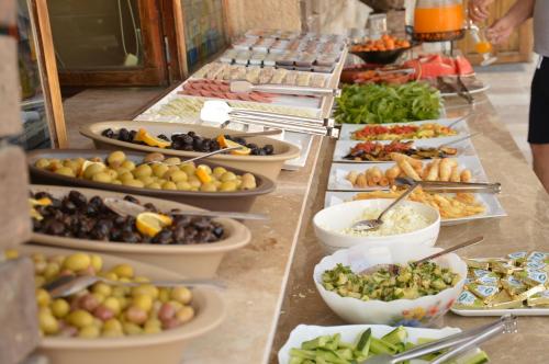 a buffet line with many different types of food at Elite Cave Suites in Goreme