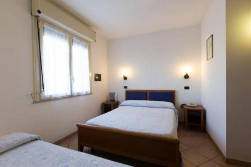 Postel nebo postele na pokoji v ubytování Albergo Cenni