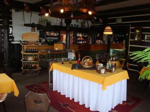 a bar with a yellow and white table in a room at Moravská Bouda in Špindlerův Mlýn